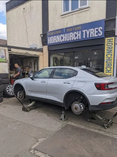 Polestar 2 electric car with all four wheels removed for tyre change at Hornchurch Tyres