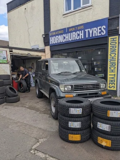 Classic Toyota Land Cruiser 4x4 with new tyres being fitted at Hornchurch Tyres, Essex