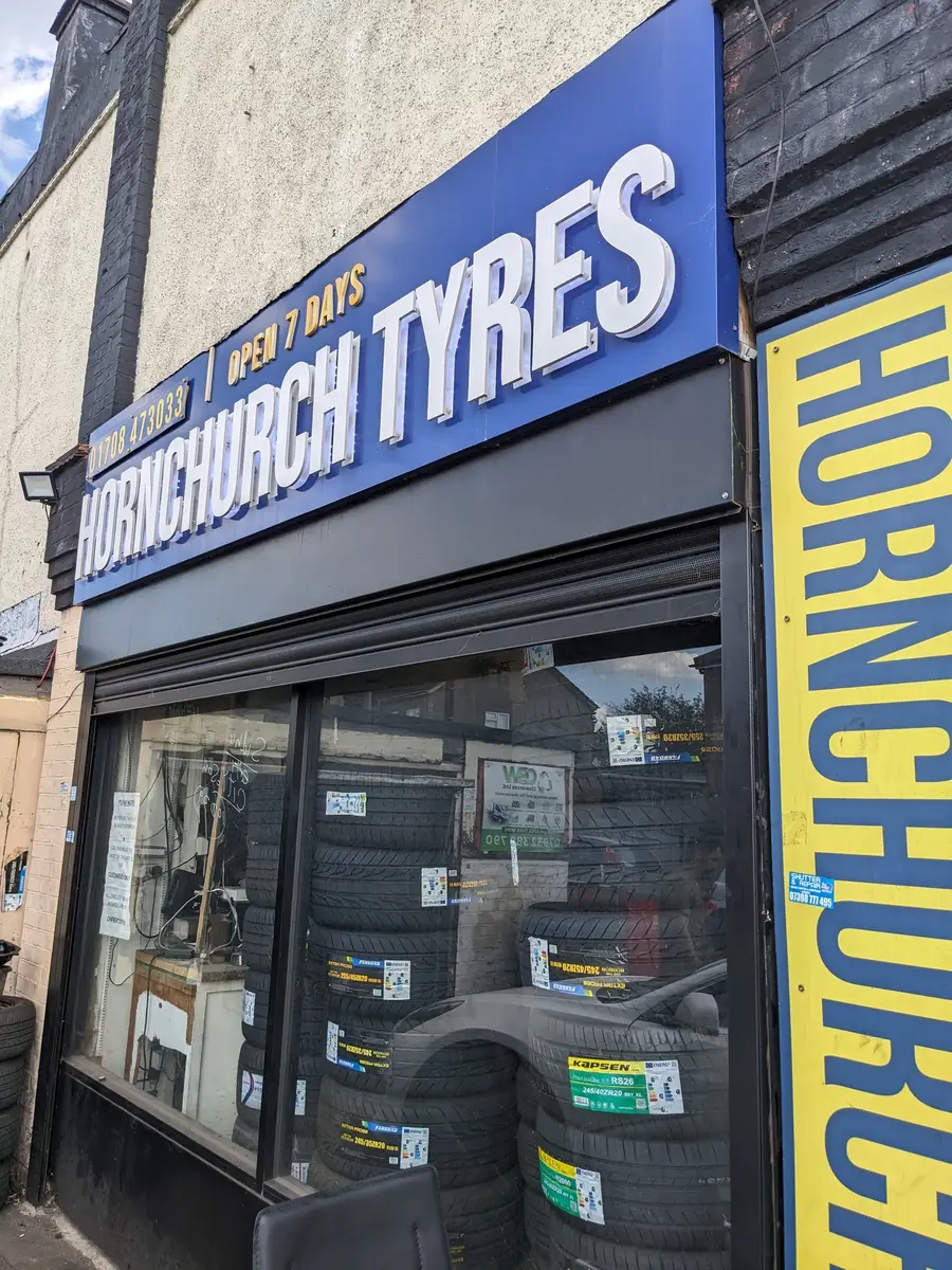 Hornchurch Tyres sign on Hornchurch Road showing the shop name and phone number